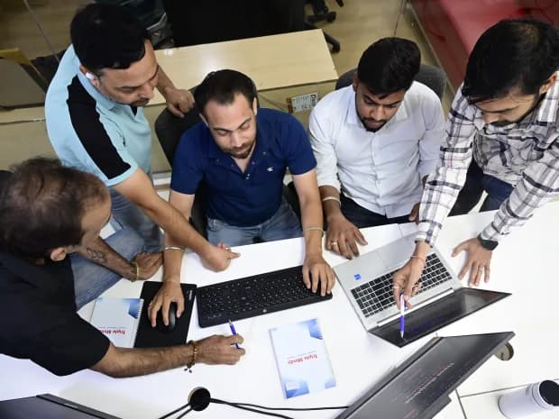 Casino SEO specialists reviewing iGaming rankings together on laptops