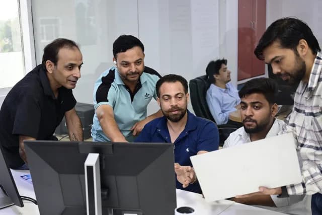 SEO Circular team reviewing an SEO campaign on a monitor
