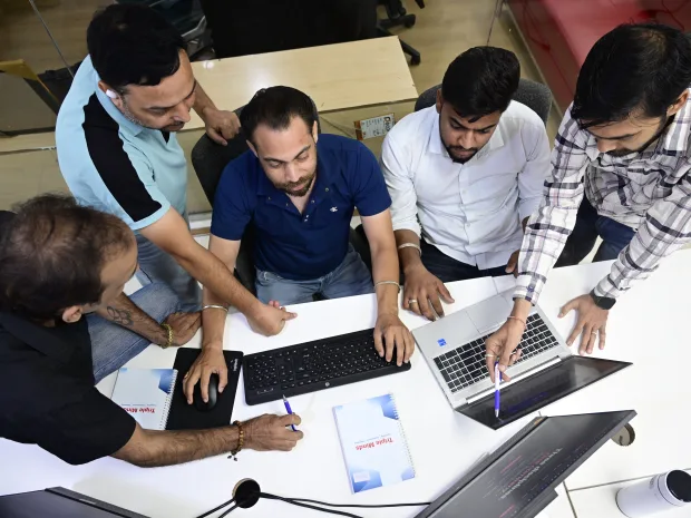 Casino SEO specialists reviewing iGaming rankings together on laptops