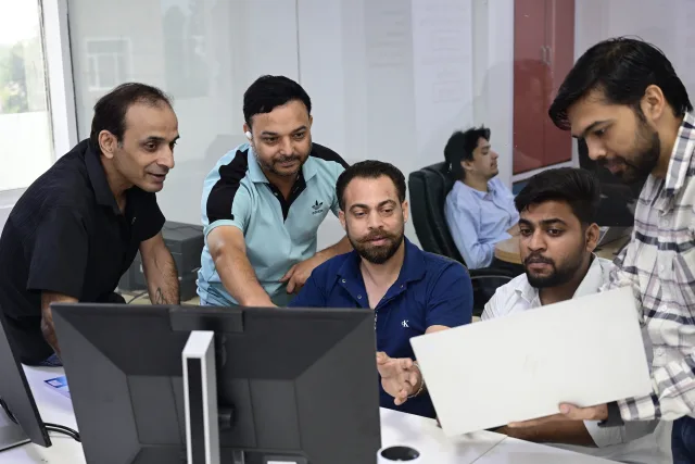 SEO Circular team reviewing an SEO campaign on a monitor
